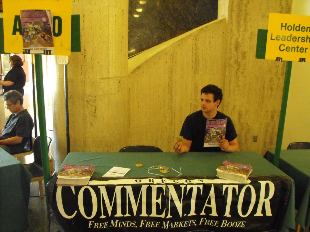 OC Editor-In-Chief tries to lure freshmen to the dark side. Note Sudsy all over the ASUO's business, top left.